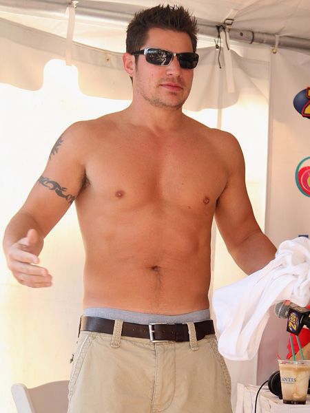 Showing his ex Jessica Simpson exactly what she's missing the stacked singer chooses his wardrobe carefully for a beach party in the Bahamas. The topless look is definitely one that gets our seal of approval- we demand all men with six packs dress like Nick  <br />
