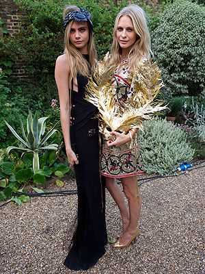 <p>In a double fashion whammy, the Delevingne sisters wowed in fancy dress at The Elephant Family presents 'The Animal Ball' party in London on Tuesday. Cara Delevingne opted for a black maxi that accentuated her long limbs, and accessorised with a black YSL shoulder bag and beaded headband. Meanwhile, sister Poppy went for gold in an embellished dress, heels and dramatic mask. </p>