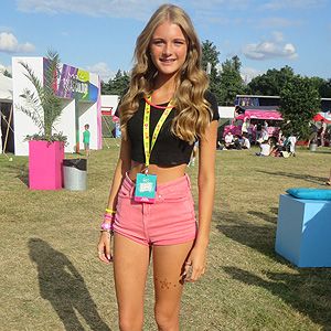 <p>Ellis erred on the right side of girly at V Festival. Showing off her toned, tanned limbs in too-cute pink shorts and a black crop-top, she added to edge to her look with a pair of well-worn Nike Blazers - and we love her frilly ankle socks!</p>