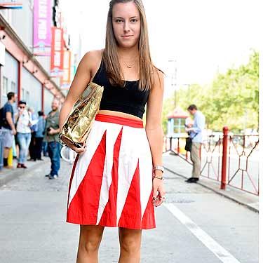 <p>Theresa adds a pop of colour to her outfit with a statement Anthropologie skirt and metallic Phillip Lim bag. We LOVE.</p>