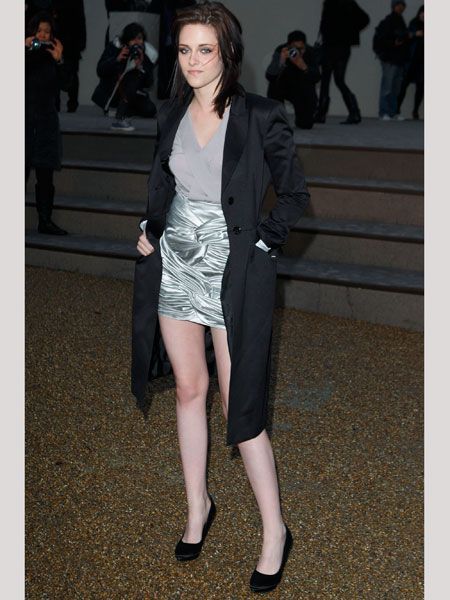 The actress joined the Burberry front row wearing a silver mini and over-sized blazer jacket