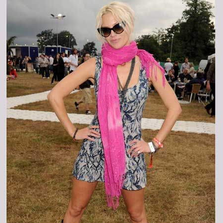 <p>The Girls Aloud singer added some serious glamour to the field-based frolics at V in her floating frock with a fuchsia scarf that added a bold punch to her look, then toughen it up with biker boots and added superstar status with winged shades </p>