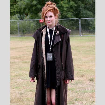 <p>Marking out her territory as a style icon the Dr Who actress kept both her beauty and fashion simple with a black dress, dramatic long coat complimented with relaxed hair in the form of a loose top knot. As the rain poured down, Karen didn't run for cover she danced all through the showers - we love her! </p>