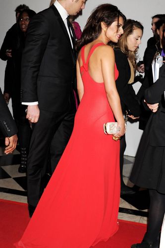 Cheryl wowed in this sheer floor-length red gown, showing off her toned back and shoulders as she chatted to her team.