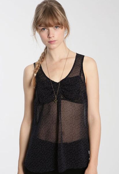 <p>Sheer blouses are sizzling this season. Whilst this won't keep you warm it will look super hot come Saturday night</p>

<p>£38, <a target="_blank" href="http://www.urbanoutfitters.co.uk/Ecote-Sleeveless-Paisely-Bow-Front-Blouse/invt/5110462178742&bklist=icat,5,shop,womens,womenscollections,newforspringwomens">urbanoutfitters.co.uk</a>   </p>