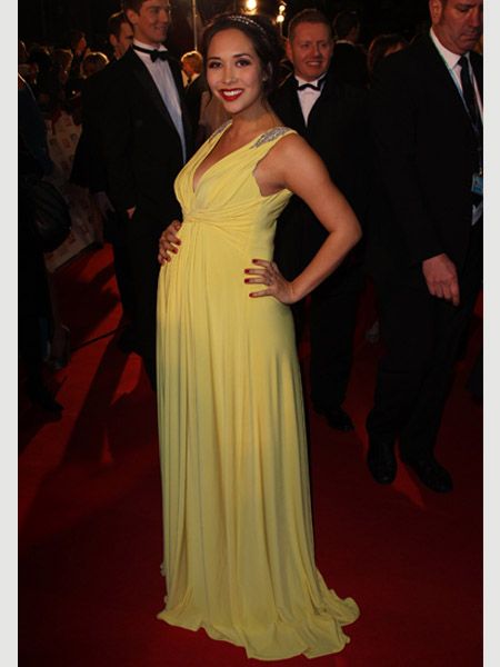 Beaming with her baby bump Myleene was all smiles as she took to the red carpet in a stunning pale yellow floor-length gown. Accessorising with bright red lips and nails the M&S model was certainly working the yummy mummy look