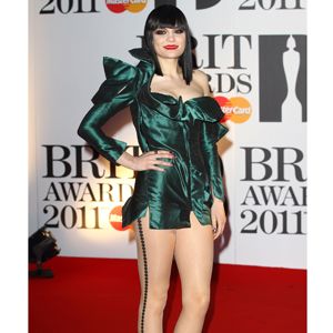 Jessie went all out in an architectural emerald green mini dress with statement hosiery and tasselled ankle boots