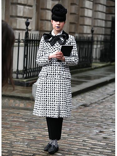 <p>This stylish lady looked anything but boring in an all black and white ensemble – we love the patterned socks peeping out from below her trousers, not to mention the pop of blue on her lips!</p>