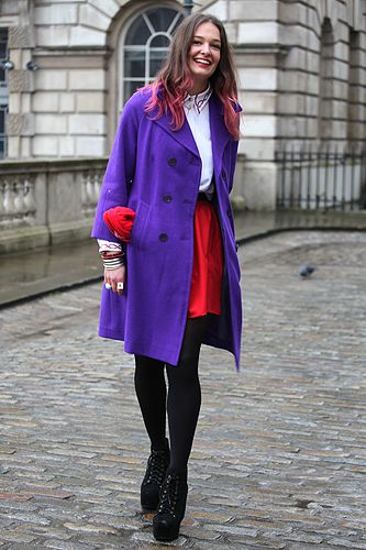 <p>Determined not to let a bit of rain spoil the fashion week fun, this lady wore dazzling colours to match her dip-dyed hair</p>