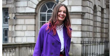 <p>Determined not to let a bit of rain spoil the fashion week fun, this lady wore dazzling colours to match her dip-dyed hair</p>