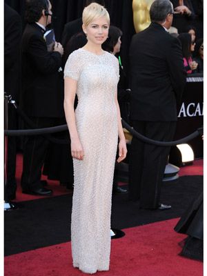<p>Sparkling in a white sequined Chanel dress with capped sleeves, Michelle Williams completed her Oscar 2011 outfit with a pair of trusty Jimmy Choos</p>