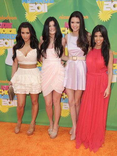 <p>Kim, Kylie and Kendall went for short frocks in pale shades whilst Kourtney opted for a hot-hued maxi dress, and all wore their dark locks long and loose</p>