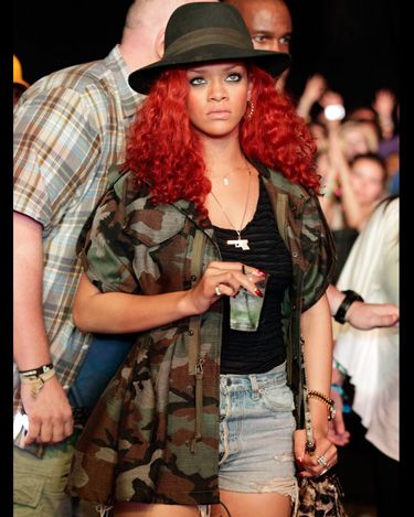 <p>Rihanna was pictured in the crowd taking cover in a camouflage jacket, khaki hat and the festival staple - shorts and vest combo</p>