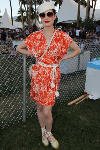 <p>Coachella's field location didn't put a stop to Dita's glamorous fashion personality but she did brighten up for the occasion with an unusually loud tangerine frock and lime espadrilles</p>