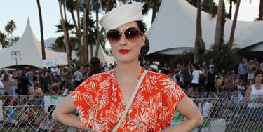 <p>Coachella's field location didn't put a stop to Dita's glamorous fashion personality but she did brighten up for the occasion with an unusually loud tangerine frock and lime espadrilles</p>