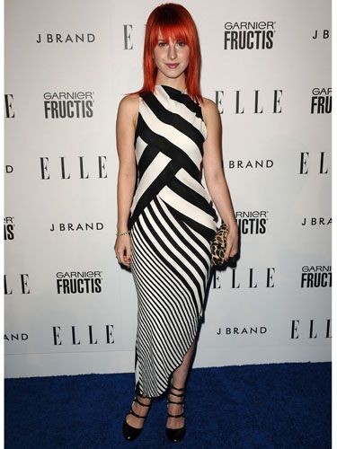 <p>Hayley goes for a more mature look in this stripy monochrome dress at Elle's Women in Music event this year. We love her leopard print clutch</p>