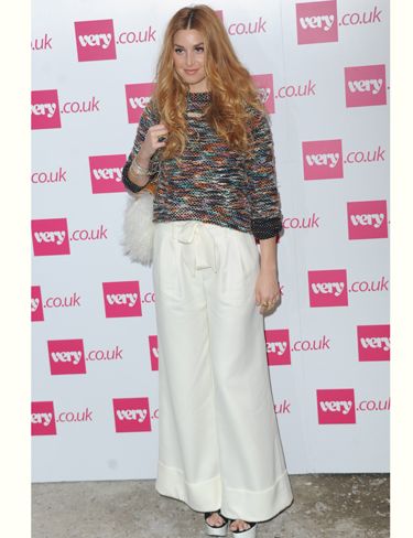 <p>Whitney Port will be selling her own clothing line, Whitney Eve on <a href="http://www.very.co.uk/web/en/celebrity-style.page">very.co.uk</a> from October and came to London to show Fearne Cotton support at her show. She worked the 70s trend in these super wide white flares and check out her fluffy bag!</p>
