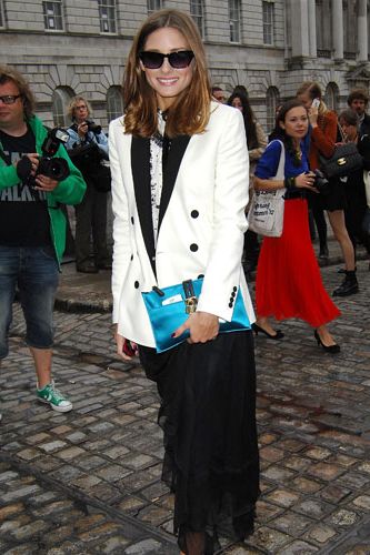 <p>Olivia had the paps - and the fashion pack - in a frenzy at this September's London Fashion Week, hitting the shows in a series of statement outfits. We're loving this take on the classic tuxedo jacket; she gave the style a fresh daytime twist by choosing a white tux from Whistles which she paired with an ultra-feminine black silk maxi skirt.</p>
