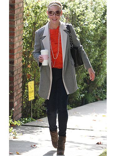 Orange is our one of our favourite shades right now – not only is it it versatile, it also cheers up the dullest of days. Katherine teamed her bright orange top with skinny jeans, big shades and a grey blazer. Civvie chic