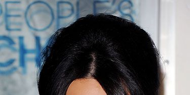 Kim Kardashian ALWAYS has super-perfect hair! Whether she wears her locks sleek and straight, or swept up into a tousled updo as pictured, Kim's hair  means multi-millionaire business

