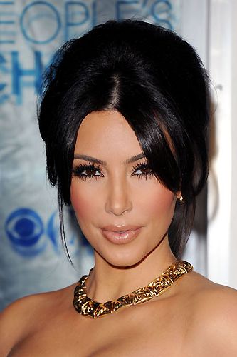 Kim Kardashian ALWAYS has super-perfect hair! Whether she wears her locks sleek and straight, or swept up into a tousled updo as pictured, Kim's hair  means multi-millionaire business
