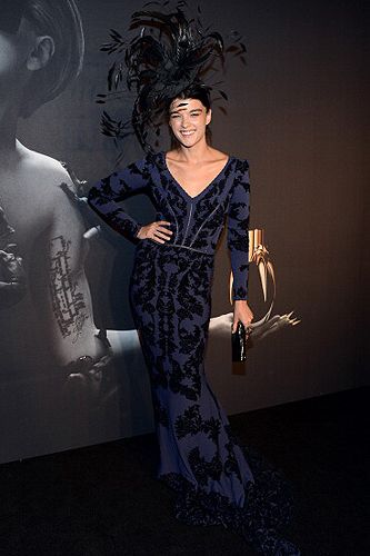 <p>Model Crystal Renn attended the Lady Gaga fragrance launch in a slim navy mermaid gown and a massive black feather headpiece. She looked like she came right out of the Black Swan movie!</p>