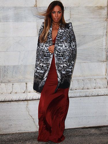 <p>Singer Leona Lewis wore a gorgeous dark red dress with a huge split up the side – ooh, how very Angelina! Leona took her front place on the front row at the Roberto Cavalli show. She paired her frock with an black and white coat which screamed 'Milan Fashion Week'.</p>