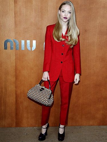 <p>We love Amanda Seyfried's colour-popping look on the Frow at the Miu Miu show in Paris. Wearing a mannish trouser suit in red, teamed with purple patent Mary Jane heels and a geometric print doctor's bag (this season's must-have shape!), the actress topped off her look with a vampy berry lip and poker straight hair. Talk about a head-to-toe look!</p>