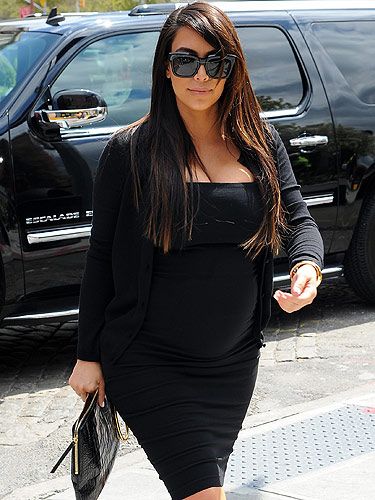 <p>Kim Kardashian has been very open about her struggle to stylishly dress her growing baby bump – but that's exactly what she did to great effect as she kept things classic in a black strapless dress worn with a simple cardie and a patent clutch. Sometimes simple is spot on.<strong> </strong></p>