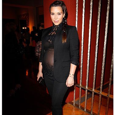 <p>Who says you can't look and feel sexy as a pregnant lady? Kim Kardashian does both as she dons a slimming all-black look featuring black trousers and a blazer that are given an evening edge with a sheer top with lace appliqué. You go girl!</p>