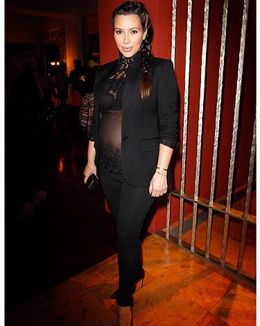 <p>Who says you can't look and feel sexy as a pregnant lady? Kim Kardashian does both as she dons a slimming all-black look featuring black trousers and a blazer that are given an evening edge with a sheer top with lace appliqué. You go girl!</p>