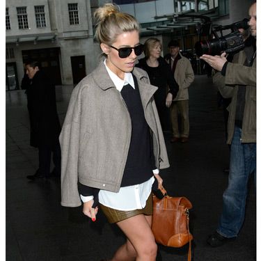 <p>Ooh, look! Mollie King is doing the Victoria Beckham-coat-on-shoulders thing - and she's working it! This outfit is very different for Mollie; it's almost preppy. We gotta say, we love her for trying out a new look. The Saturdays babe was leaving the BBC Radio One studios in London, but brrr, are those bare legs?</p>