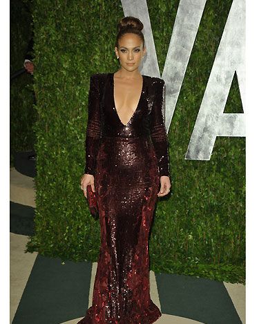 Jennifer Lopez swapped one revealing Zuhair Murad plunging v-neck dress for another at the Vanity Fair Oscar Party; this time a deep red gown, and thankfully no nip-slip for J-Lo second time round! It's worth noting that we're in lust with her red to black ombre crystal Allegro clutch by Swarovski - divine!
