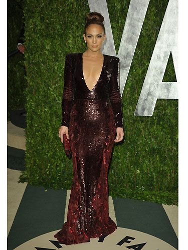 Jennifer Lopez swapped one revealing Zuhair Murad plunging v-neck dress for another at the Vanity Fair Oscar Party; this time a deep red gown, and thankfully no nip-slip for J-Lo second time round! It's worth noting that we're in lust with her red to black ombre crystal Allegro clutch by Swarovski - divine!
