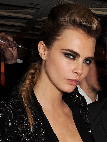 <p>We're hugely enjoying this statement hairdo on Cara with its punky quiff and equestrian plait. The bold eye makeup takes the androgyneity of her tresses into power glamour territory. Well played.</p>
<p>Get the look with the <a title="http://uk.burberry.com/store/beauty-fragrance/eyes/complete-eye-palette/prod-38660731-complete-eye-palette-dark-spice-no05/" href="http://uk.burberry.com/store/beauty-fragrance/eyes/complete-eye-palette/prod-38660731-complete-eye-palette-dark-spice-no05/" target="_blank">Burberry Complete Eye Palette in Dark Spice</a>, £40</p>