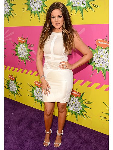 <p>Wow, could Khloé Kardashian look any hotter? The reality tv star clearly wasn't afraid of getting slime on her Antonio Berardi dress as she chose white to attend the 2013 Nickelodeon Kids' Choice Awards in LA. Khloé fitted her fabulous curves into a white bodycon style dress and accessorised with matching sandals and loads of bling.</p>