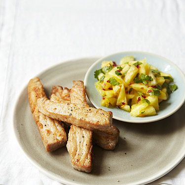 <p>238 calories</p>
<p><em>The bold flavours of the pineapple salsa complement the tuna in this dish.</em></p>
<p><strong>Serves:</strong> 2 </p>
<p><strong>Preparation time:</strong> 10 minutes </p>
<p><strong>Cook time:</strong> 5 minutes</p>
<p><strong>Ingredients:</strong></p>
<p>1 x 225g (8oz) can pineapple chunks in juice, drained and chopped into small chunks (106 cals)</p>
<p>¼ tsp chilli flakes </p>
<p>1 small handful of fresh coriander, finely chopped (3 cals)</p>
<p>1 tsp lemon juice</p>
<p>2 x 200g fresh tuna steaks (272 cals)</p>
<p>1 level tbsp plain (all-purpose) flour, seasoned with salt and freshly ground black pepper (68 cals)</p>
<p>1 tsp olive oil (27 cals)</p>
<p><strong>Preparation:</strong></p>
<p>Combine the chopped pineapple, chilli flakes , coriander and lemon juice in a small bowl and set aside while you prepare the tuna.</p>
<p>Cut each tuna steak into four strips and toss in the seasoned flour until just coated.</p>
<p>Heat the olive oil in a frying pan over a high heat. The oil needs to be glimmering hot before adding the tuna. Fry the tuna for just 1–2 minutes, turning once. </p>
<p>Pile the salsa onto two serving plates, arrange the tuna strips on top and serve.</p>