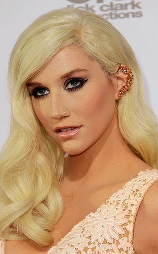<p>Ke$ha isn't exactly known for her demure style, so naturally she chose a spiky ear cuff to edge up her look at the American Music Awards this year. The choice of little orange flowers to match her dress was pretty nice touch.</p>