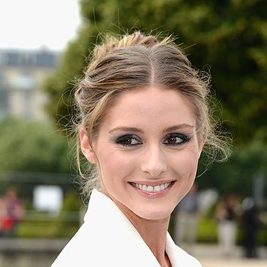 <p>Olivia's chic hairstyle is un-done but well done to a T. Texture is the secret, so before you try a 'thrown-up' bun like this, prep your hair with a body-building product and bend some strands around a styling wand if your hair is naturally straight.</p>