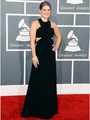 <p>Kelly Osbourne showed off her trim figure in a simple yet effective cut-out black Paule Ka dress at the 2013 Grammy awards. The Fashion Police presenter accessorised with a chunky H Stern gold bracelet and matching earring and we just love her sleek purple ponytail.</p>
