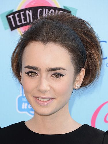 <p>Working 60s-inspired beauty like a pro, Lily Collin wowed with her beehive updo. Sweeping her long locks into a faux bob wrapped up in a chic black headband, Lily was totally channeling Audrey Hepburn with this look.  We absolutely love it!</p>