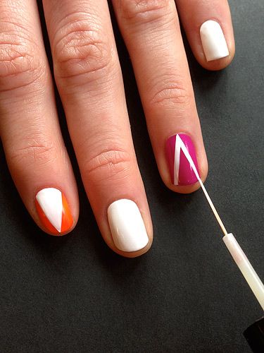 <p>On the orange and purple painted nails paint on a triangle with the striping brush in white polish. Vary the direction of the triangle on each nail, so, place one triangle pointing towards the tip on one nail and a triangle pointing to the cuticle on another.</p>