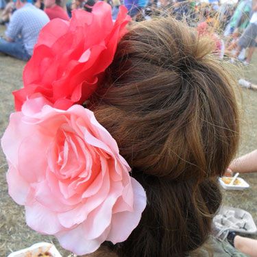 <p>A big, tousled bun is a definite festival winner. Using a hair donut can give the illusion of voluminous, blow-dried locks, when secretly they're just covered in dry shampoo and you want them away from your neck.</p>
<p>Two giant flowers make for an extra touch of fun.</p>