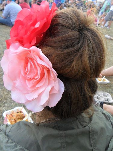 <p>A big, tousled bun is a definite festival winner. Using a hair donut can give the illusion of voluminous, blow-dried locks, when secretly they're just covered in dry shampoo and you want them away from your neck.</p>
<p>Two giant flowers make for an extra touch of fun.</p>