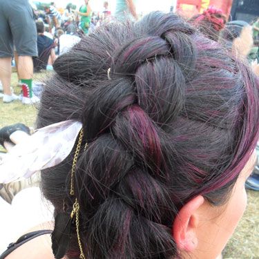 <p>Plaits are back in a very big way, and this thick braid caught our attention at Reading this year. We're loving the lighter coloured streaks that are woven through the braid, and wearing it on the side of your crown is a new take on an old classic.</p>
<p>Also, nice feather.</p>