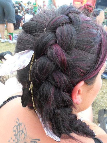 <p>Plaits are back in a very big way, and this thick braid caught our attention at Reading this year. We're loving the lighter coloured streaks that are woven through the braid, and wearing it on the side of your crown is a new take on an old classic.</p>
<p>Also, nice feather.</p>
