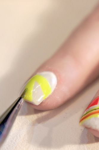 <p>Use the yellow nail polish to create a chevron.</p>