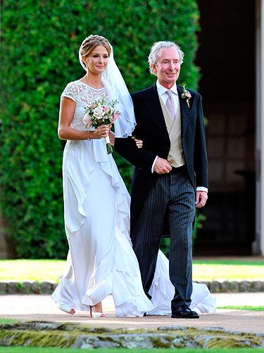 <p>We got our frist glimpse at Millie Mackintosh's vintage Alice Temperley wedding dress as she was pictured walking towards the church with her father Nigel.</p>