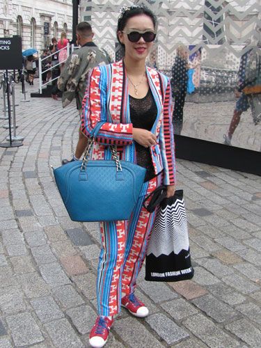 Someone's not colour shy! Against the grey weather and cobblestones, her outfit was a beacon for the paps!