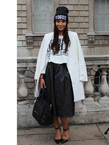 Beanie hat, sleek white crombie coat, leather midi: who said monochrome was dull? Love how she's mixed a slogan tee and bold, graphic beanie with the classic shapes of the skirt and coat. 